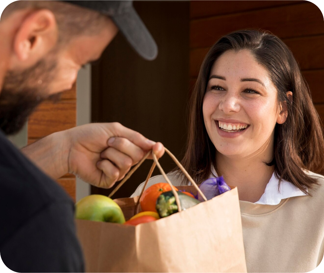 A Smood driver delivering ordered groceries to a customer.